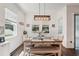 Cozy dining room with a rustic wood table, bench seating and lots of natural light at 13355 Palmerston Rd, Riverview, FL 33579