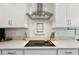 Modern kitchen with an electric cooktop, light countertops, and sleek hardware at 13355 Palmerston Rd, Riverview, FL 33579