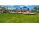 Community playground with slides and swings set against a backdrop of open green space and trees at 13355 Palmerston Rd, Riverview, FL 33579