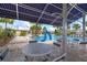 View of a poolside cabana with tables and chairs, overlooking a sparkling community pool with a slide at 13355 Palmerston Rd, Riverview, FL 33579