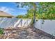 View of the backyard showing the wooden fence, landscaping, mature trees, and a clean, well-kept area at 1505 Trailwater St, Ruskin, FL 33570