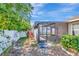 Backyard view featuring a covered patio and decorative fence with colorful foliage and landscaping at 1505 Trailwater St, Ruskin, FL 33570