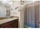 Bathroom with shower, patterned shower curtain, granite vanity, and nautical-themed decorations at 1505 Trailwater St, Ruskin, FL 33570