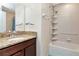 Bathroom with granite countertop vanity and a shower-tub combination with tiled walls and chrome fixtures at 1505 Trailwater St, Ruskin, FL 33570