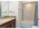 Bathroom with granite topped vanity, and a shower/tub combination with white tiled surround and shower curtain at 1505 Trailwater St, Ruskin, FL 33570
