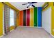 Bright bedroom with vibrant color accents, a ceiling fan, and ample closet space at 1505 Trailwater St, Ruskin, FL 33570