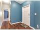 Inviting entryway with wood floors and a white door, offering a warm welcome at 1505 Trailwater St, Ruskin, FL 33570