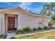 Inviting single Gathering home featuring a solid wood front door and tropical landscaping at 1505 Trailwater St, Ruskin, FL 33570