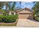 Charming single-story home with a well-manicured front yard and a two-car garage under a partly cloudy sky at 1505 Trailwater St, Ruskin, FL 33570