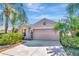 Attractive single-story home with a two-car garage, stone accents, and established landscaping at 1505 Trailwater St, Ruskin, FL 33570