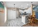 Well-lit kitchen and breakfast bar area, showcasing the stainless-steel appliances and white cabinets at 1505 Trailwater St, Ruskin, FL 33570