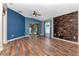 Bright living room showcasing modern wood accent wall, with a sliding door and windows at 1505 Trailwater St, Ruskin, FL 33570