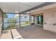 A view of the screened patio area with sliding glass doors into the house, and view of the backyard at 1505 Trailwater St, Ruskin, FL 33570