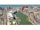 Expansive aerial view of waterfront property with private docks, showcasing nearby beach and amenities at 159 Medallion Blvd # H, Madeira Beach, FL 33708