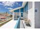 Inviting balcony with waterfront view, cozy seating, and stylish decor for outdoor relaxation at 159 Medallion Blvd # H, Madeira Beach, FL 33708
