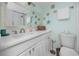 This light and airy bathroom boasts a spacious white vanity, decorative starfish, and modern fixtures at 159 Medallion Blvd # H, Madeira Beach, FL 33708