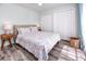 A bright bedroom features a comfortable bed with closets, a basket, and soothing coastal decor at 159 Medallion Blvd # H, Madeira Beach, FL 33708