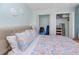 A soothing bedroom features a cozy bed, coastal wall decor, and ample closet space at 159 Medallion Blvd # H, Madeira Beach, FL 33708