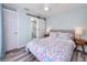 A delightful bedroom showcases a charming bed, sliding barn door to a bathroom, and tasteful coastal-inspired decor at 159 Medallion Blvd # H, Madeira Beach, FL 33708