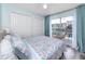 Inviting bedroom with water view, closet and coastal-themed bedding at 159 Medallion Blvd # H, Madeira Beach, FL 33708