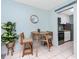 A cozy dining area with seating for two, complemented by a view into the modern kitchen at 159 Medallion Blvd # H, Madeira Beach, FL 33708