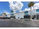 Exterior view of well-maintained waterfront condos with assigned parking and lush landscaping at 159 Medallion Blvd # H, Madeira Beach, FL 33708