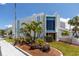 Bright white two-story office building with blue accents, lush landscaping, and clearly marked entrances at 159 Medallion Blvd # H, Madeira Beach, FL 33708