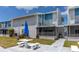 Exterior view of condo building featuring a private patio, grassy area, and walkway access at 159 Medallion Blvd # H, Madeira Beach, FL 33708