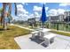 Inviting outdoor space featuring a table with attached seating near a waterfront at 159 Medallion Blvd # H, Madeira Beach, FL 33708