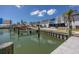 Scenic waterfront view featuring docks, manicured landscaping, and assigned seating areas for outdoor enjoyment at 159 Medallion Blvd # H, Madeira Beach, FL 33708
