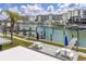 Picturesque waterfront view featuring a marina, docks, and seating areas for relaxing by the water at 159 Medallion Blvd # H, Madeira Beach, FL 33708
