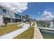 Charming waterfront scene showcasing docks, assigned seating, and lush landscaping along the waterway at 159 Medallion Blvd # H, Madeira Beach, FL 33708