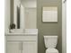 Well-lit bathroom with a white vanity, modern fixtures, and a neutral color scheme at 17512 Shirewood Way, Land O Lakes, FL 34638