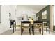 Open-concept dining area with a wooden table, stylish chairs, and sleek modern design at 17512 Shirewood Way, Land O Lakes, FL 34638