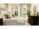Airy main bedroom with a large mirror, neutral palette, and ample natural light at 17512 Shirewood Way, Land O Lakes, FL 34638