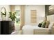 Bright main bedroom with natural light, modern decor, and a view of the outdoors at 17512 Shirewood Way, Land O Lakes, FL 34638