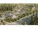 Expansive aerial view of a Primary-planned community with lush landscaping, gardens, and community buildings at 17518 Shirewood Way, Land O Lakes, FL 34638