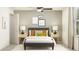 Inviting bedroom featuring a full-size bed, olive and gold pillows, and a neutral color scheme at 17518 Shirewood Way, Land O Lakes, FL 34638