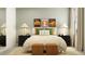 Stylish main bedroom featuring neutral tones, complementary lamps and woven ottomans at 17518 Shirewood Way, Land O Lakes, FL 34638