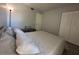 Cozy bedroom with a plush bed, warm lighting, and ample closet space at 1799 N Highland Ave # 32, Clearwater, FL 33755