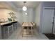 Well-lit dining area with a stylish table, seating for four, and adjacent kitchen bar at 1799 N Highland Ave # 32, Clearwater, FL 33755