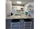 Charming kitchen features granite countertops, white cabinets, and functional breakfast bar at 1799 N Highland Ave # 32, Clearwater, FL 33755