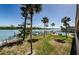 Beautiful waterfront backyard featuring lush landscaping, a dock, and a community pool, perfect for outdoor enjoyment at 18201 Gulf Blvd # 201, Redington Shores, FL 33708