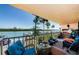 Cozy balcony featuring views of the water and docks, perfect for relaxing and enjoying the waterfront scenery at 18201 Gulf Blvd # 201, Redington Shores, FL 33708