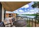 Scenic balcony showcasing a table and chairs with a tranquil canal view and boat dock at 18201 Gulf Blvd # 201, Redington Shores, FL 33708
