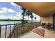 Relaxing balcony with canal view and boat dock, plus a table and chairs at 18201 Gulf Blvd # 201, Redington Shores, FL 33708