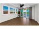 Balcony with sliding doors, shutters, ceiling fan, water view, and wood-style flooring at 18201 Gulf Blvd # 201, Redington Shores, FL 33708