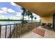 Enjoy this home's balcony with a view of the boat dock, lush landscape, and waterfront at 18201 Gulf Blvd # 201, Redington Shores, FL 33708