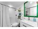 Well-lit bathroom featuring a white vanity, mirror, toilet, and a shower with a curtain at 18201 Gulf Blvd # 201, Redington Shores, FL 33708