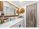 Bright bathroom featuring a large mirror, white vanity, and decorative nautical accents at 18201 Gulf Blvd # 201, Redington Shores, FL 33708